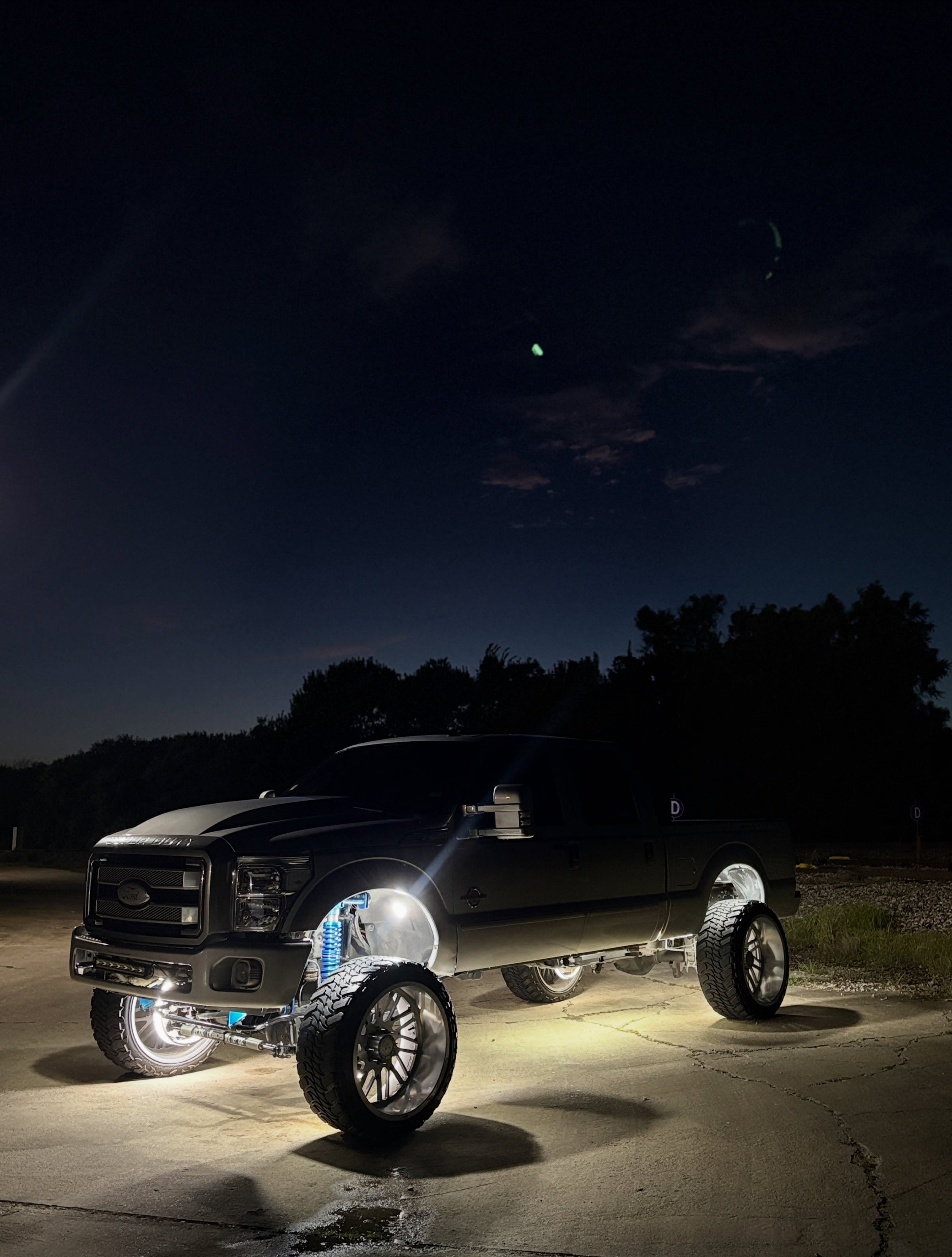 Lifted truck with tinted glass at night